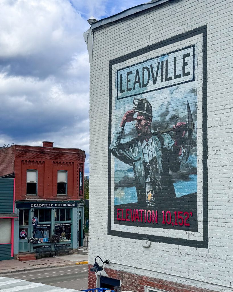 The Silver Miner mural painted on The Timberline's brick exterior
