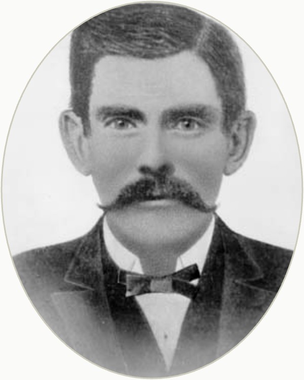 Oval-cropped portrait said to show Doc Holliday in the early 1880s, with a heavy mustache and bow tie