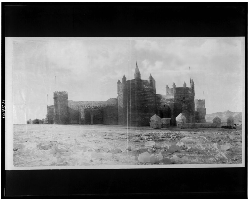 The Leadville Ice Palace in 1896, a long castle built of ice blocks with towers, seen from across a snowy field