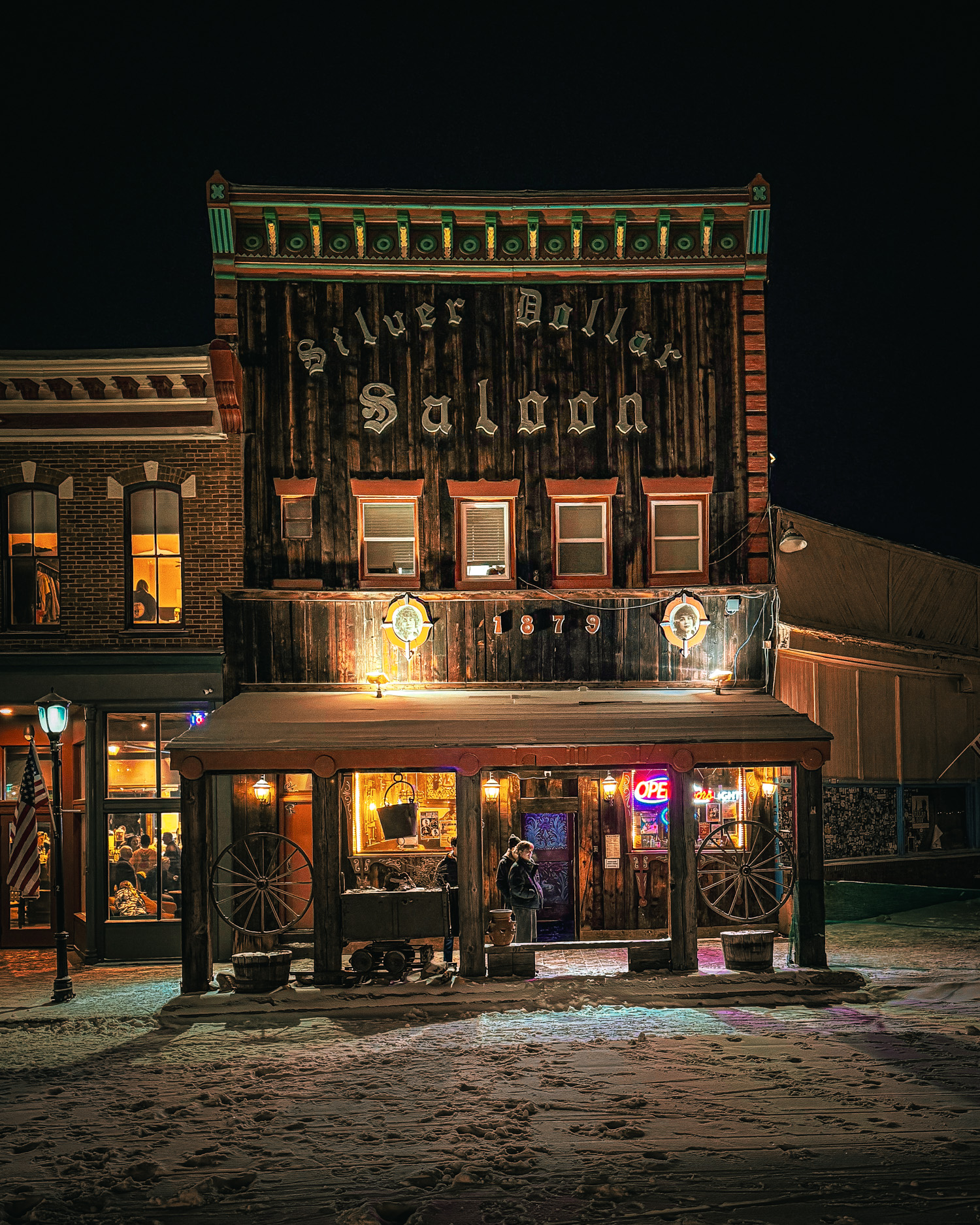 The Silver Dollar Saloon lit up on a snowy night on Harrison Avenue in Leadville